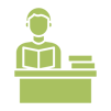 A person sitting at a desk reading a book. There is a stack of three books on the right side of the desk.